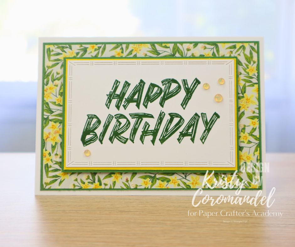 Birthday card with layered daffodil-patterned paper and bold green sentiment