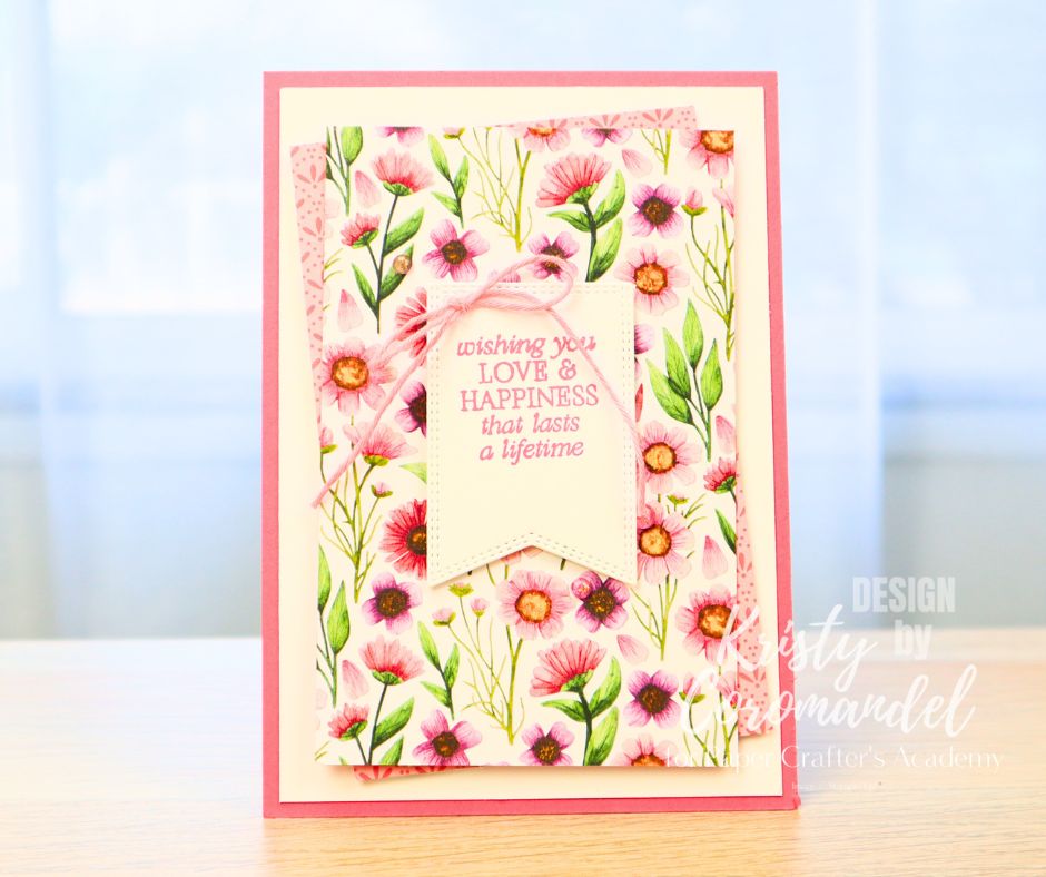 Card with floral paper and stitched sentiment tag - beginner card layering example