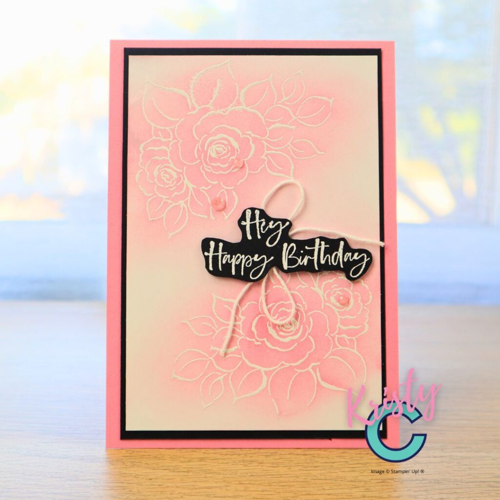 Handmade pink birthday card featuring embossed floral background with soft ink blending and white heat-embossed sentiment on black cardstock.