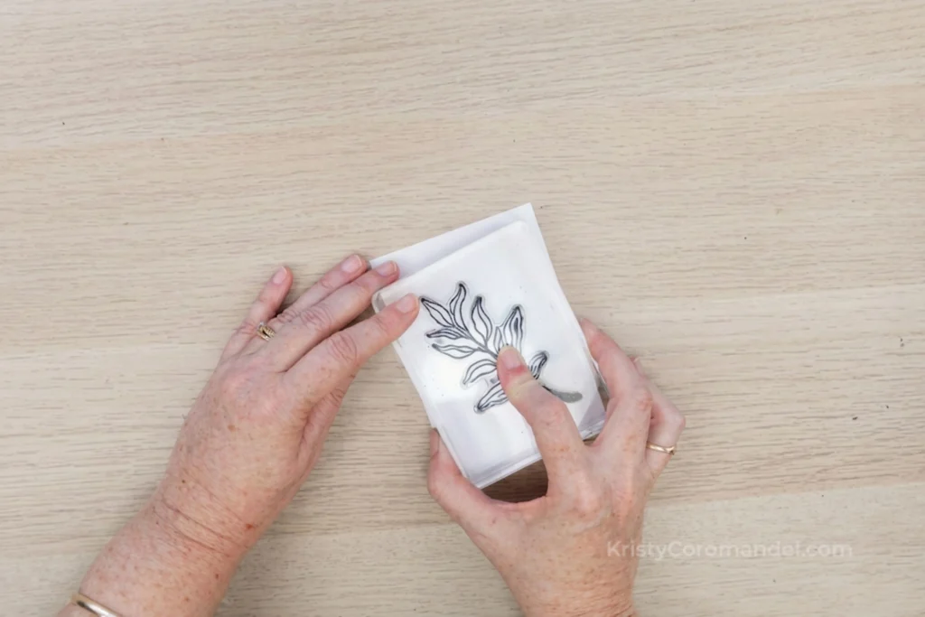 Placing an inked stamp onto white cardstock