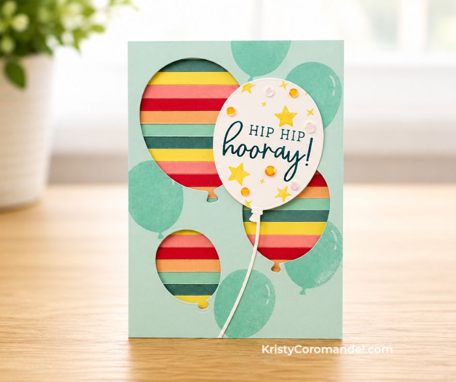 Cream birthday card featuring a large rainbow-striped balloon made from cardstock strips, gold festoon banner background, "Happy Birthday" sentiment