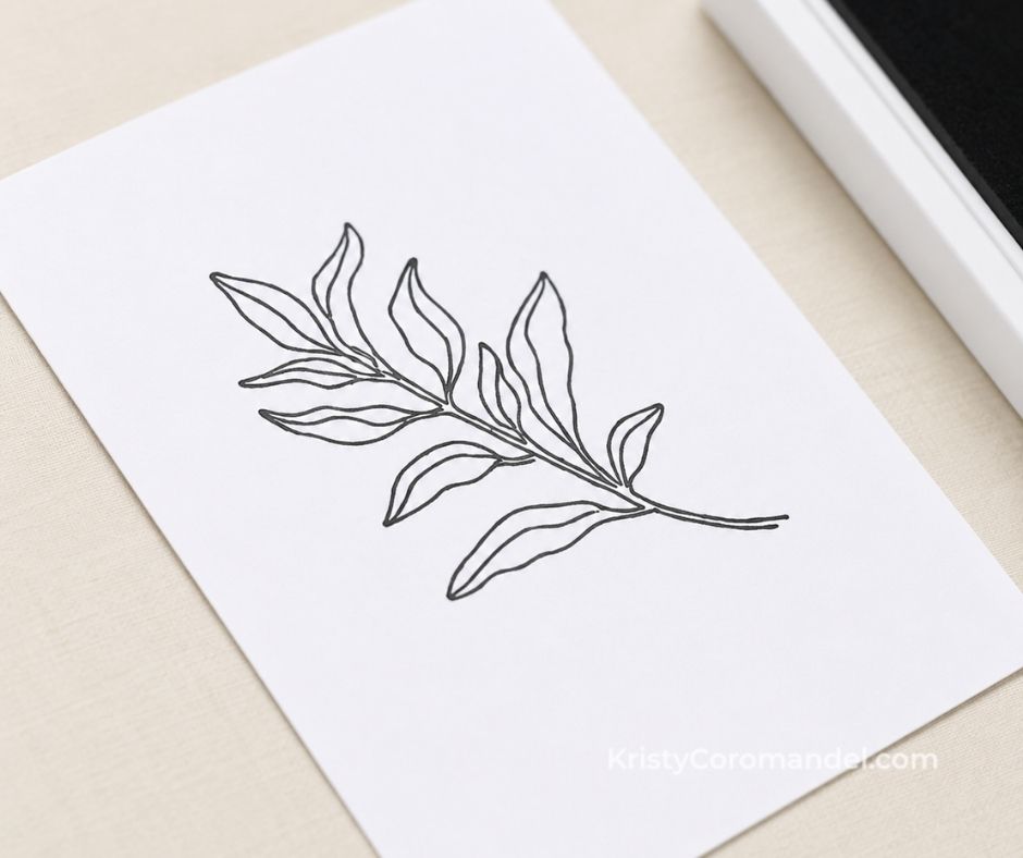 Close-up of a crisp black leaf image stamped onto smooth Basic White cardstock.
