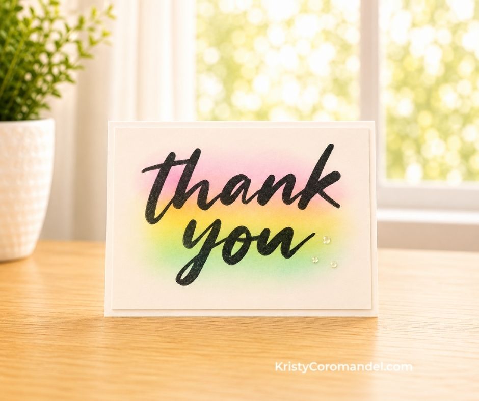 Handmade thank you card featuring a bold black sentiment over a soft pink, yellow and green ink-blended background.