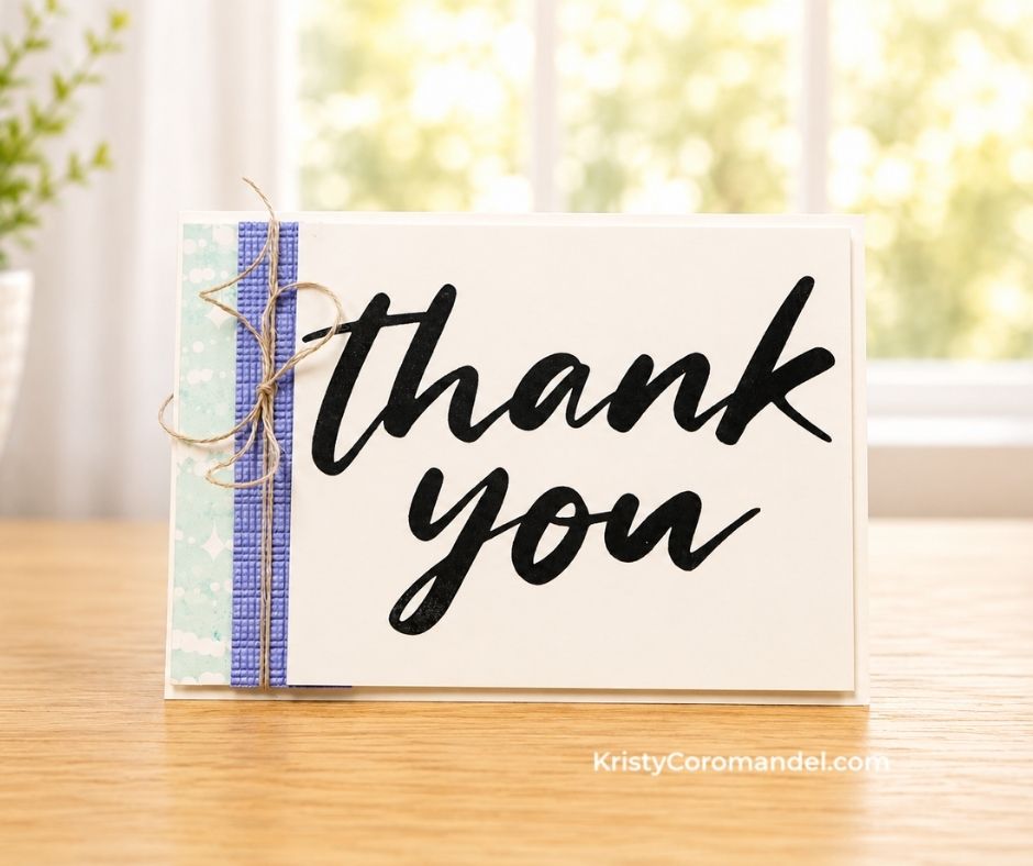 Handmade thank you card with a large black sentiment, patterned paper, textured purple cardstock and twine.