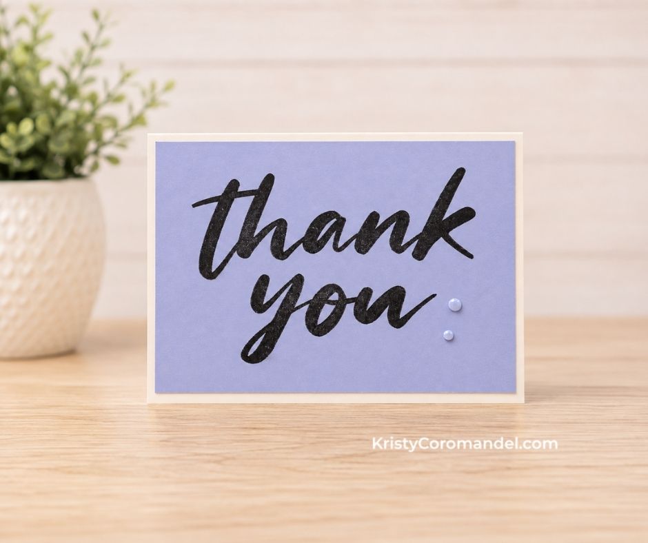 Clean and simple thank you card with a bold black sentiment stamped onto soft purple cardstock and two pearl embellishments.